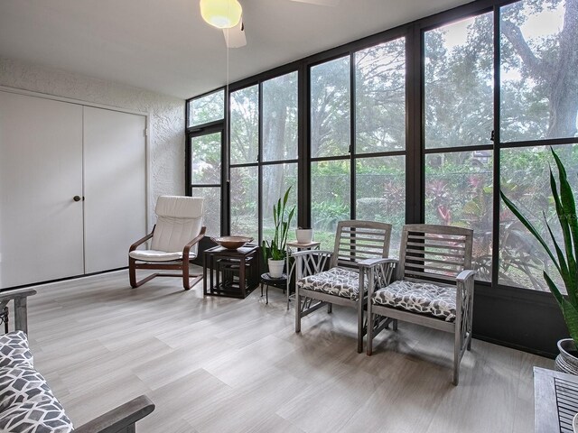 sunroom featuring ceiling fan and a wealth of natural light