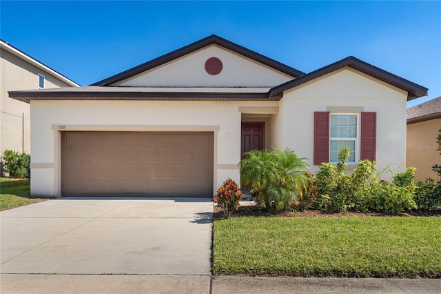 ranch-style house with a garage and a front yard