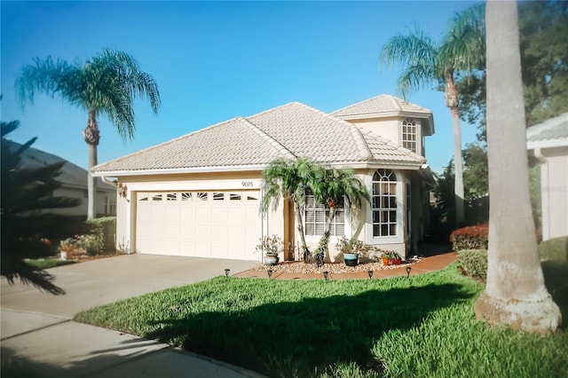 mediterranean / spanish-style house with a front yard and a garage