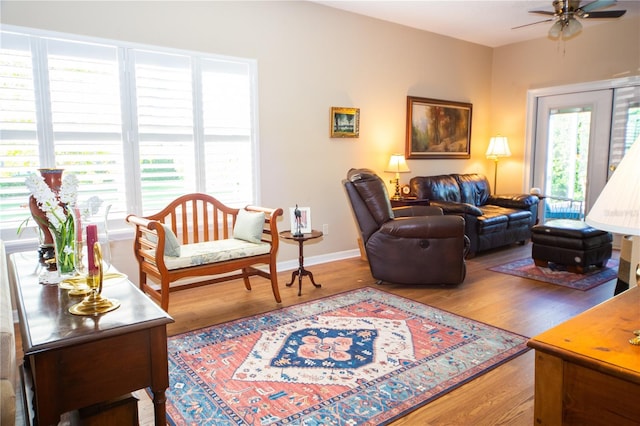 living room with plenty of natural light, hardwood / wood-style flooring, and ceiling fan