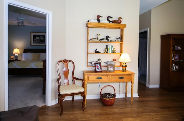 sitting room featuring ceiling fan and dark hardwood / wood-style floors