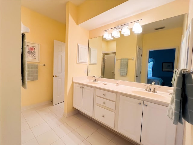 bathroom with tile patterned flooring, walk in shower, and vanity