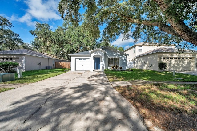 view of front facade with a front yard, a garage, and central AC