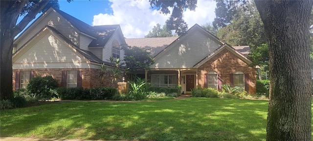 view of front of house with a front lawn and brick siding