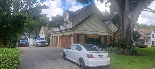 view of property exterior with a yard, brick siding, and concrete driveway