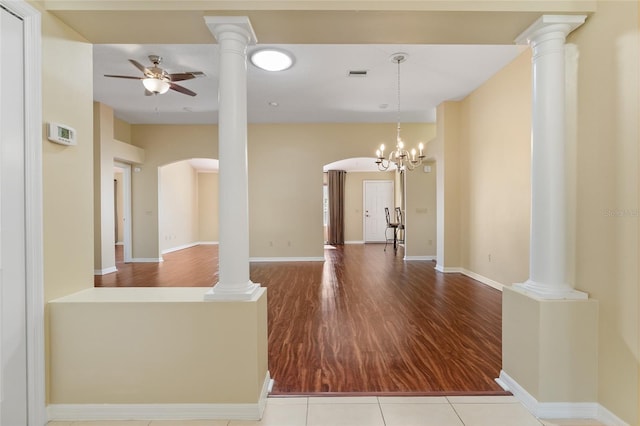 interior space with ceiling fan with notable chandelier and light hardwood / wood-style floors