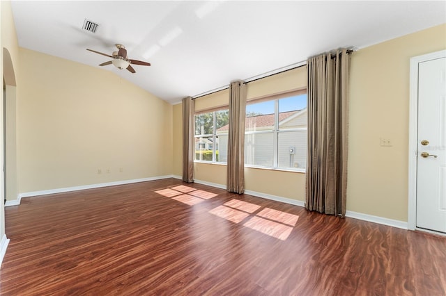 empty room with dark wood-type flooring, ceiling fan, and vaulted ceiling