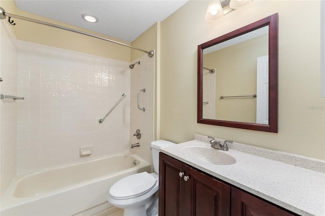 full bathroom with toilet, tiled shower / bath combo, and vanity