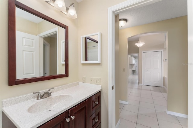 bathroom featuring vanity, a textured ceiling, and tile patterned flooring