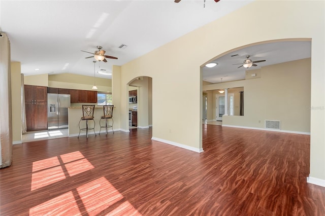 unfurnished living room with lofted ceiling and dark wood-type flooring