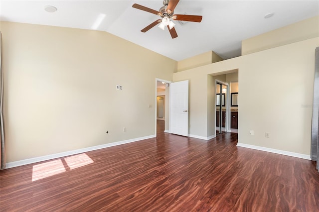 spare room featuring vaulted ceiling, dark hardwood / wood-style flooring, and ceiling fan