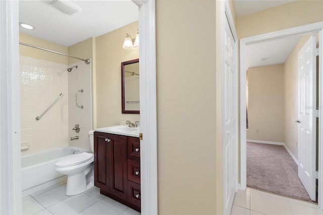 full bathroom with vanity, tiled shower / bath combo, toilet, and tile patterned flooring