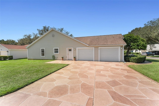 ranch-style house featuring a garage and a front lawn