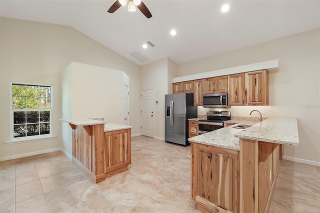 8222 Florida Boys Ranch Rd, Groveland, FL 34736 - kitchen featuring a sink, light stone countertops, stainless steel appliances, and a peninsula