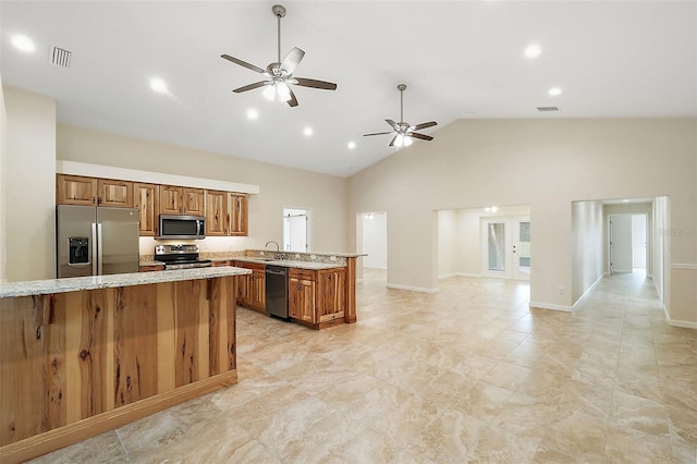8222 Florida Boys Ranch Rd, Groveland, FL 34736 - kitchen featuring brown cabinetry, visible vents, a peninsula, a sink, and appliances with stainless steel finishes