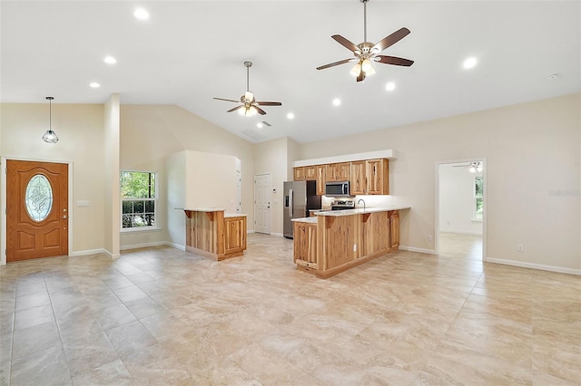 8222 Florida Boys Ranch Rd, Groveland, FL 34736 - kitchen with stainless steel appliances, high vaulted ceiling, a healthy amount of sunlight, and a peninsula