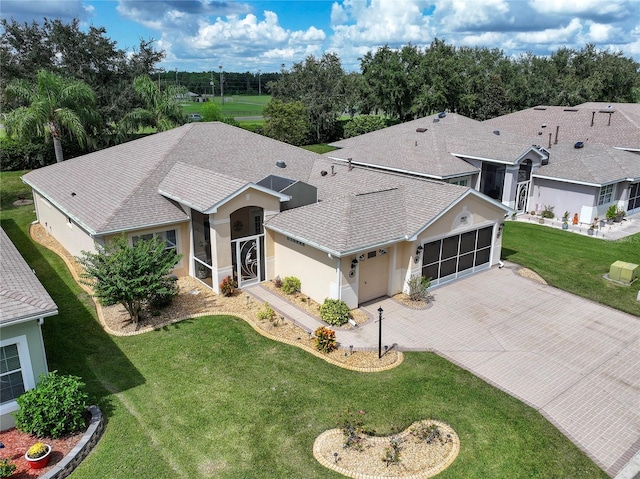 view of front of property featuring a garage and a front lawn