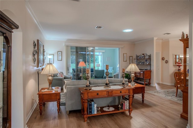 living room with hardwood / wood-style flooring and ornamental molding