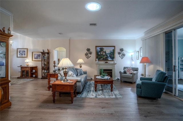 living room featuring wood-type flooring and ornamental molding