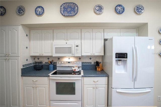 kitchen featuring white appliances and white cabinetry