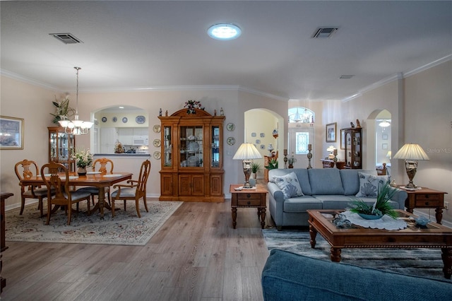 living room featuring ornamental molding and light wood-type flooring