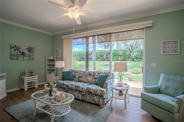 living room featuring ceiling fan, crown molding, a wealth of natural light, and wood-type flooring