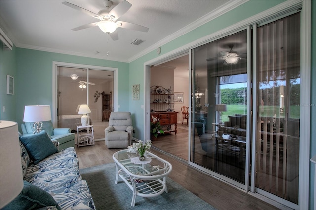 living room featuring crown molding and hardwood / wood-style floors