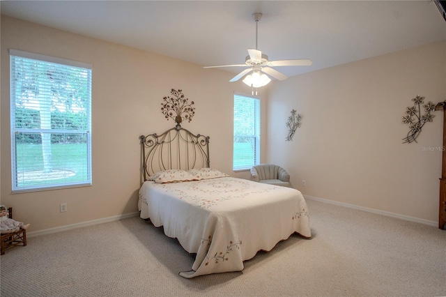 bedroom with multiple windows, ceiling fan, and carpet floors