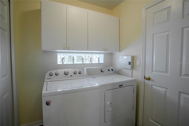 laundry area featuring independent washer and dryer and cabinets