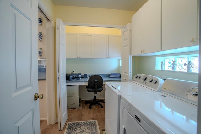 washroom with separate washer and dryer, light hardwood / wood-style flooring, and cabinets