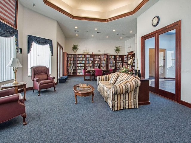 carpeted living room with a raised ceiling and a towering ceiling