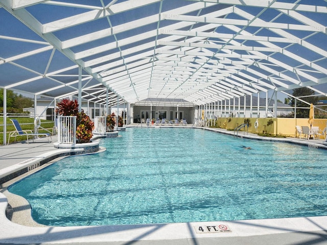 view of swimming pool with a patio and a lanai