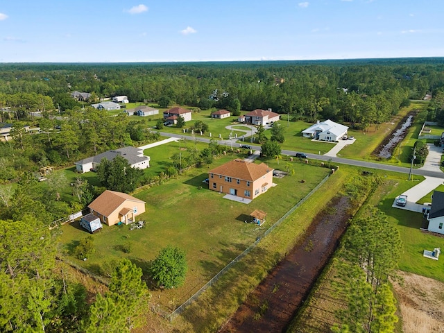 drone / aerial view with a wooded view