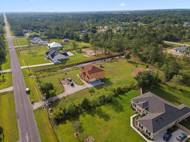 birds eye view of property featuring a view of trees