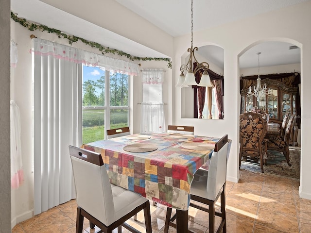 18744 Sabal St, Orlando, FL 32833 - dining space with a chandelier, arched walkways, and baseboards