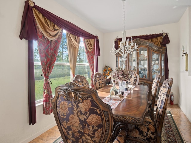 dining room with a notable chandelier and baseboards