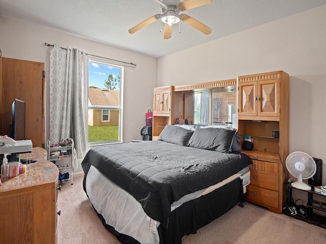 bedroom featuring a ceiling fan and light carpet