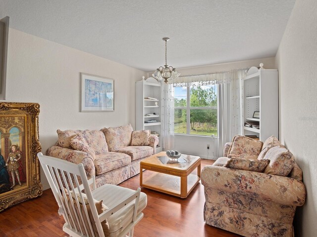 18744 Sabal St, Orlando, FL 32833 - living room with wood finished floors, a chandelier, and a textured ceiling