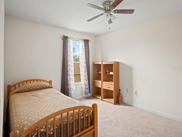 carpeted bedroom featuring ceiling fan and baseboards