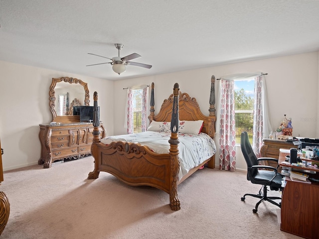 carpeted bedroom with baseboards and ceiling fan