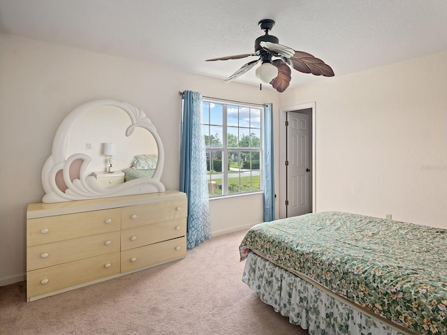 bedroom with baseboards, light colored carpet, and ceiling fan