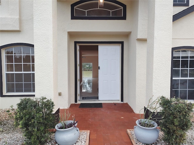 doorway to property with stucco siding