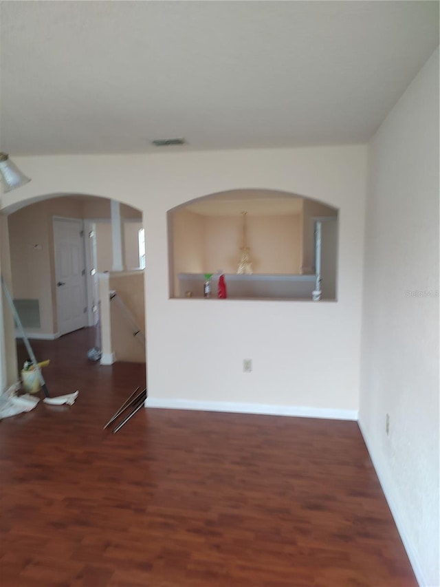 18744 Sabal St, Orlando, FL 32833 - spare room featuring arched walkways, wood finished floors, and baseboards
