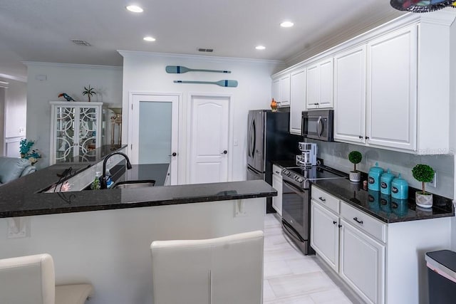 kitchen with white cabinets, backsplash, crown molding, range with electric cooktop, and sink