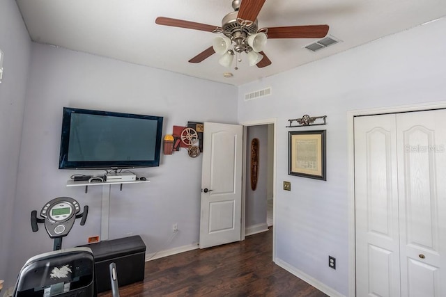 interior space with dark wood-style floors, visible vents, ceiling fan, and baseboards