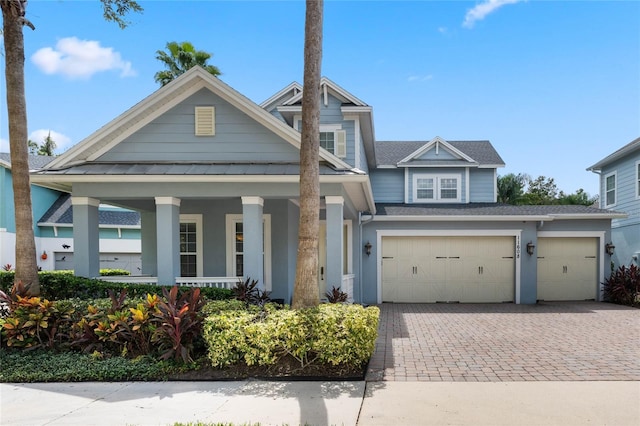 view of front of home featuring a garage and a porch