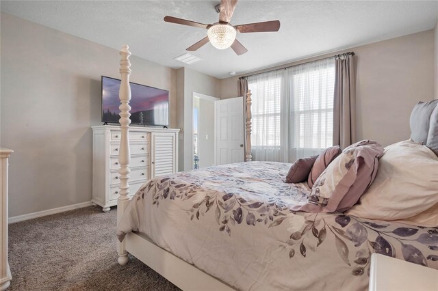 carpeted bedroom featuring ceiling fan and a textured ceiling