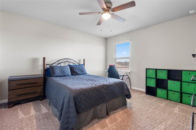 bedroom with light colored carpet, a textured ceiling, and ceiling fan