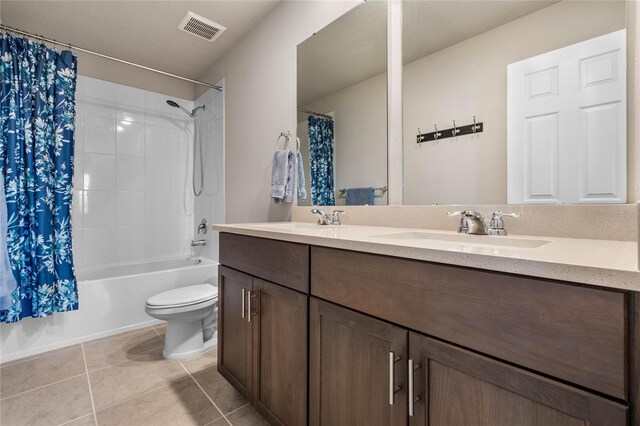 full bathroom with tile patterned flooring, shower / bathtub combination with curtain, vanity, and toilet