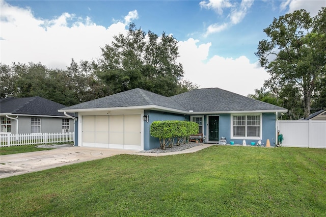 ranch-style house with a garage and a front lawn